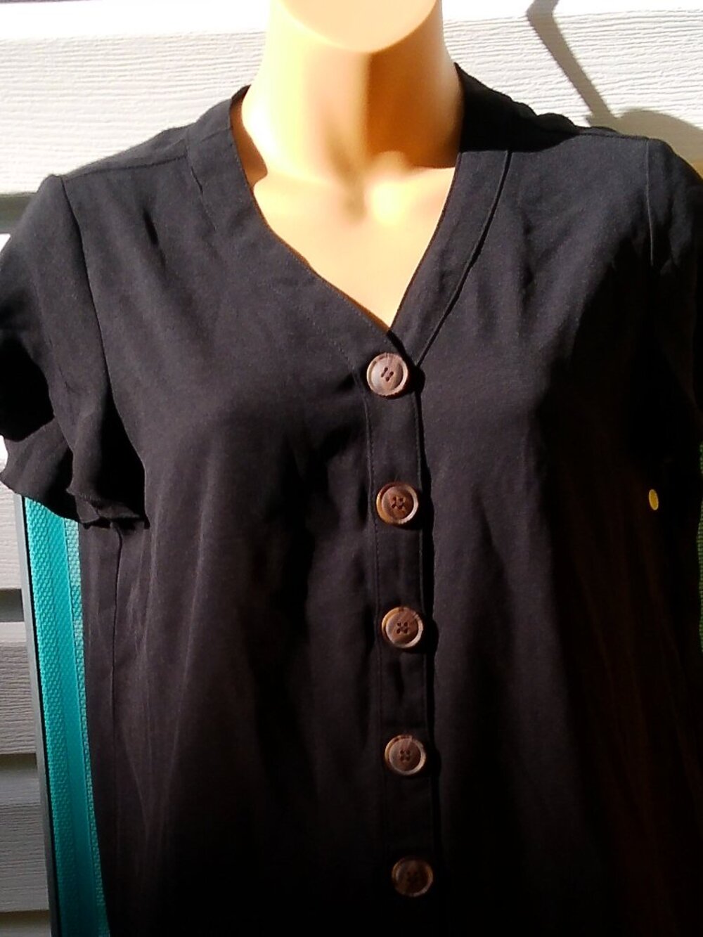BLACK DRESS NEW NO TAGS SIZE SMALL BUTTONS IN FRONT AND RUFFLE AT BOTTOM